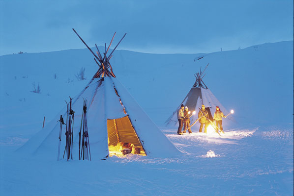 Valdres nigth evening tents with fire wigwam in snow people with fire mountain fire at nigth, Norwegen